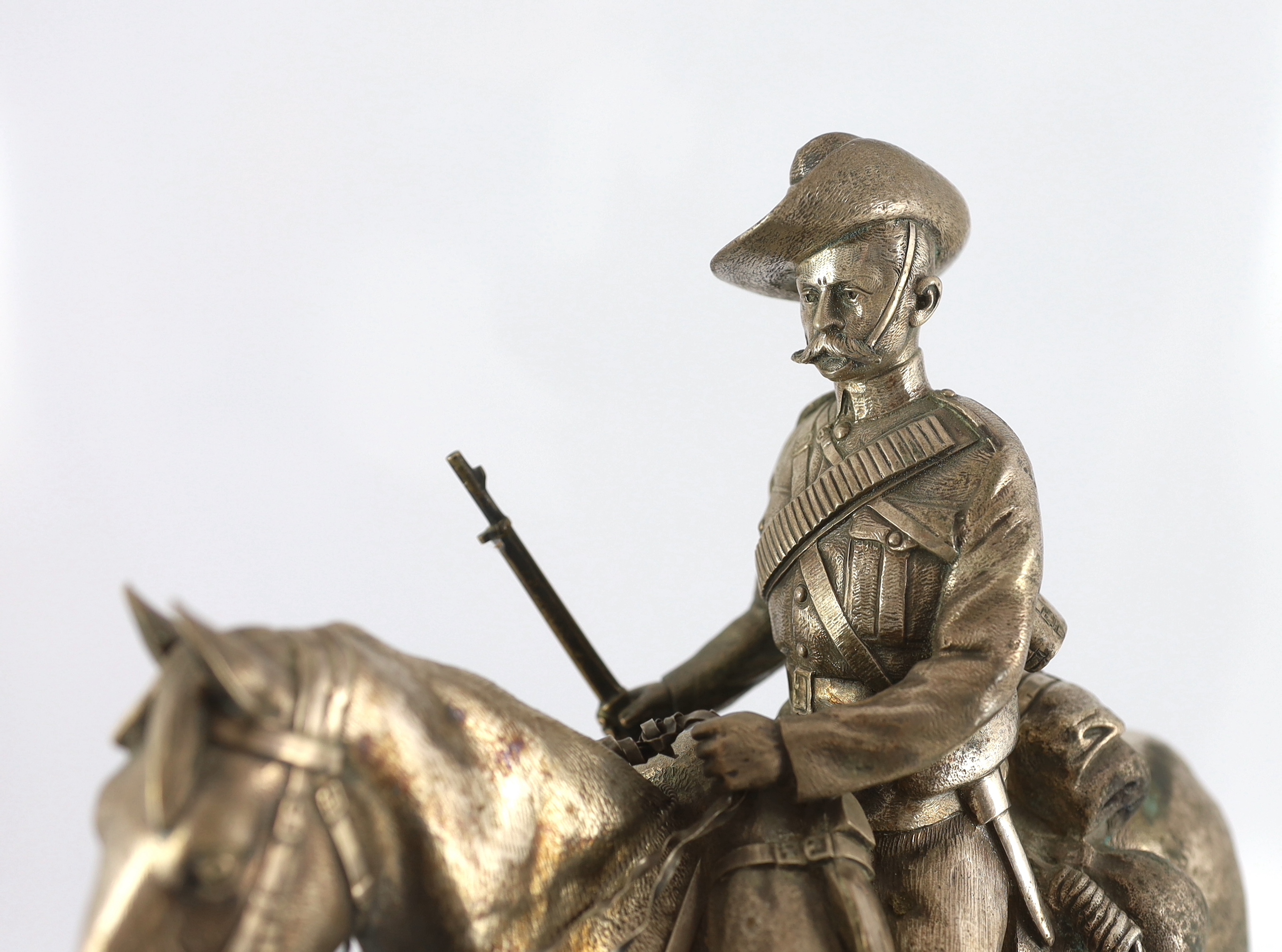 An early 20th century silver model of a City Imperial Volunteer, holding a rifle, on horseback, early 20th century